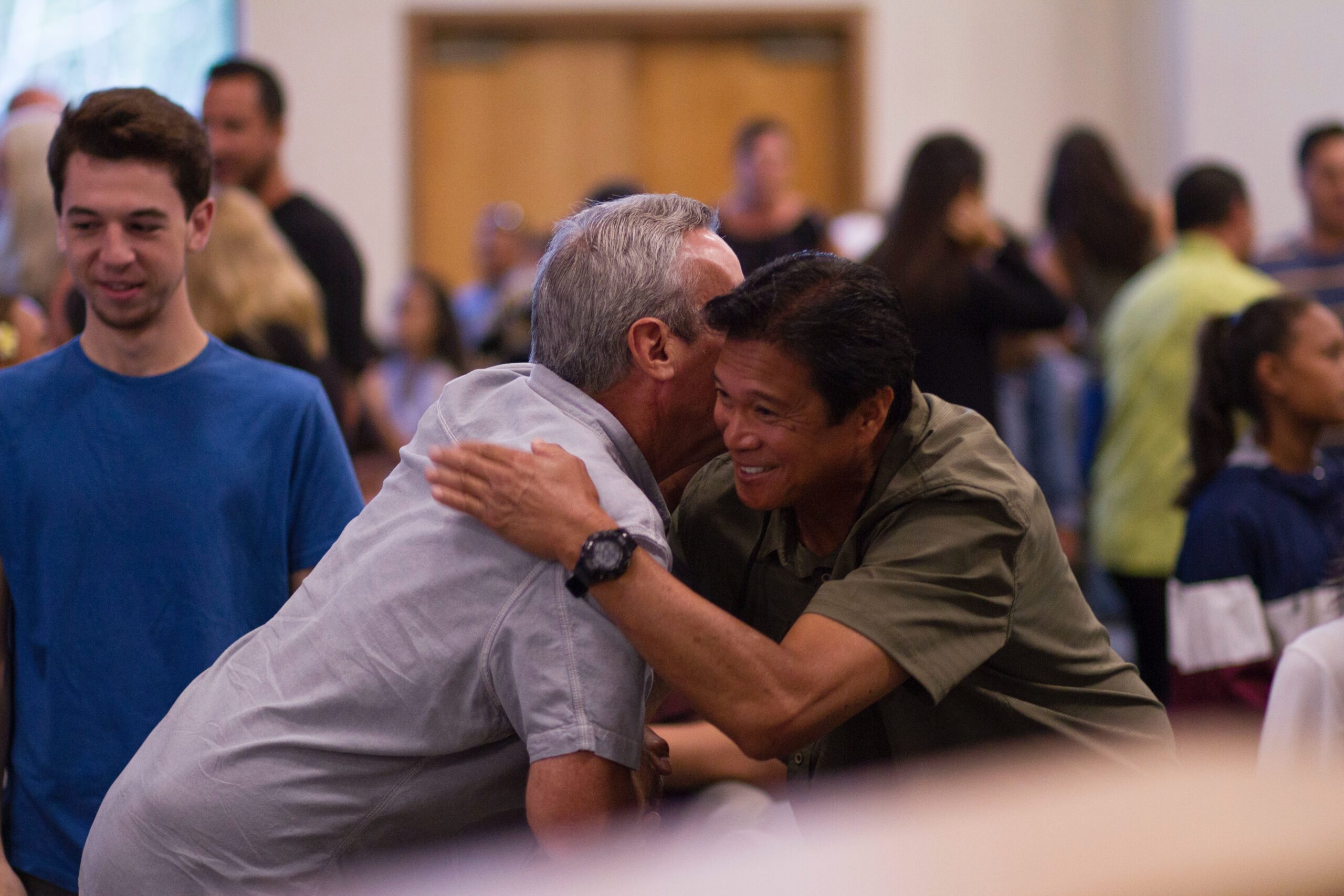 Two men in psychedelic medicine hugging and supporting each other in a mental health care community